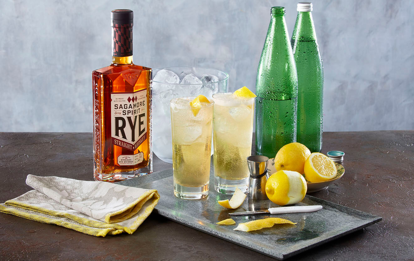 Sagamore Seltzer, bottle, cocktails and garnishes on table