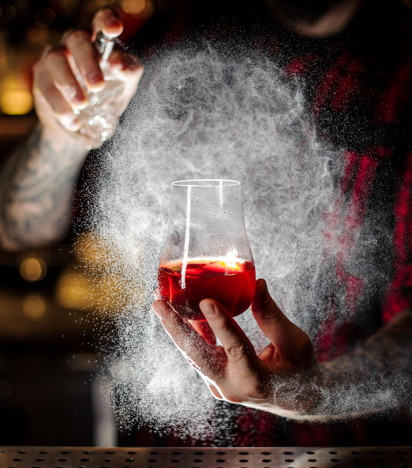 bartender spraying a sazerac cocktail