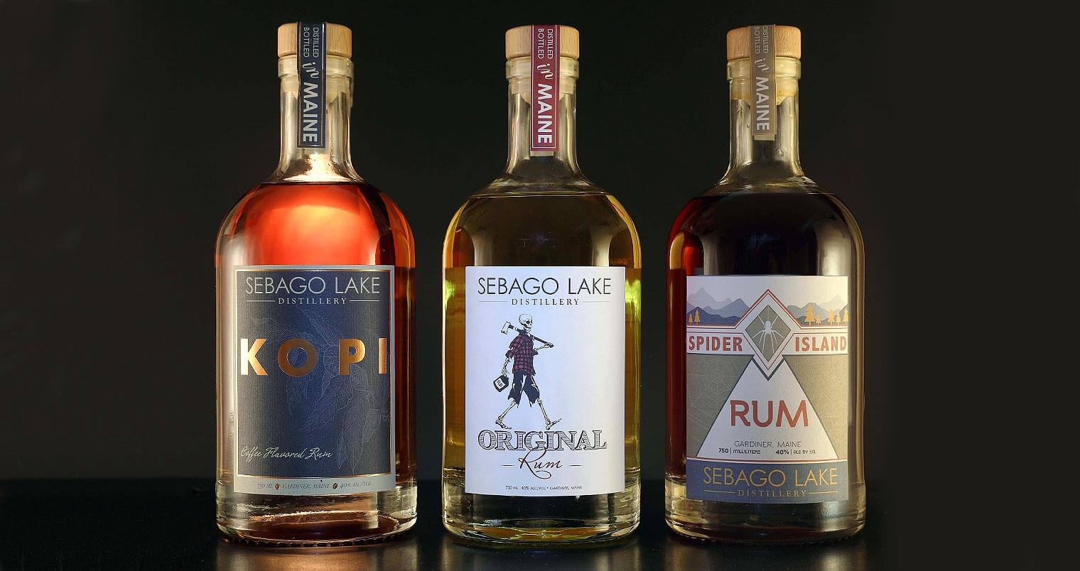 Sebago Lake Distillery High End Craft Rum, bottles on dark back, featured image