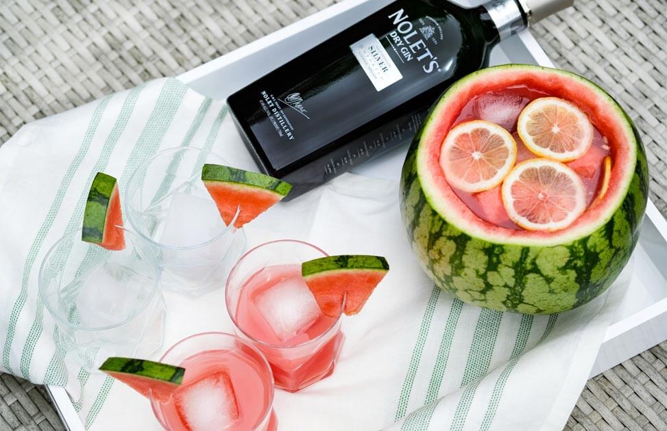 Silver Watermelon Sparkler, bottle and watermelon setup, cocktails