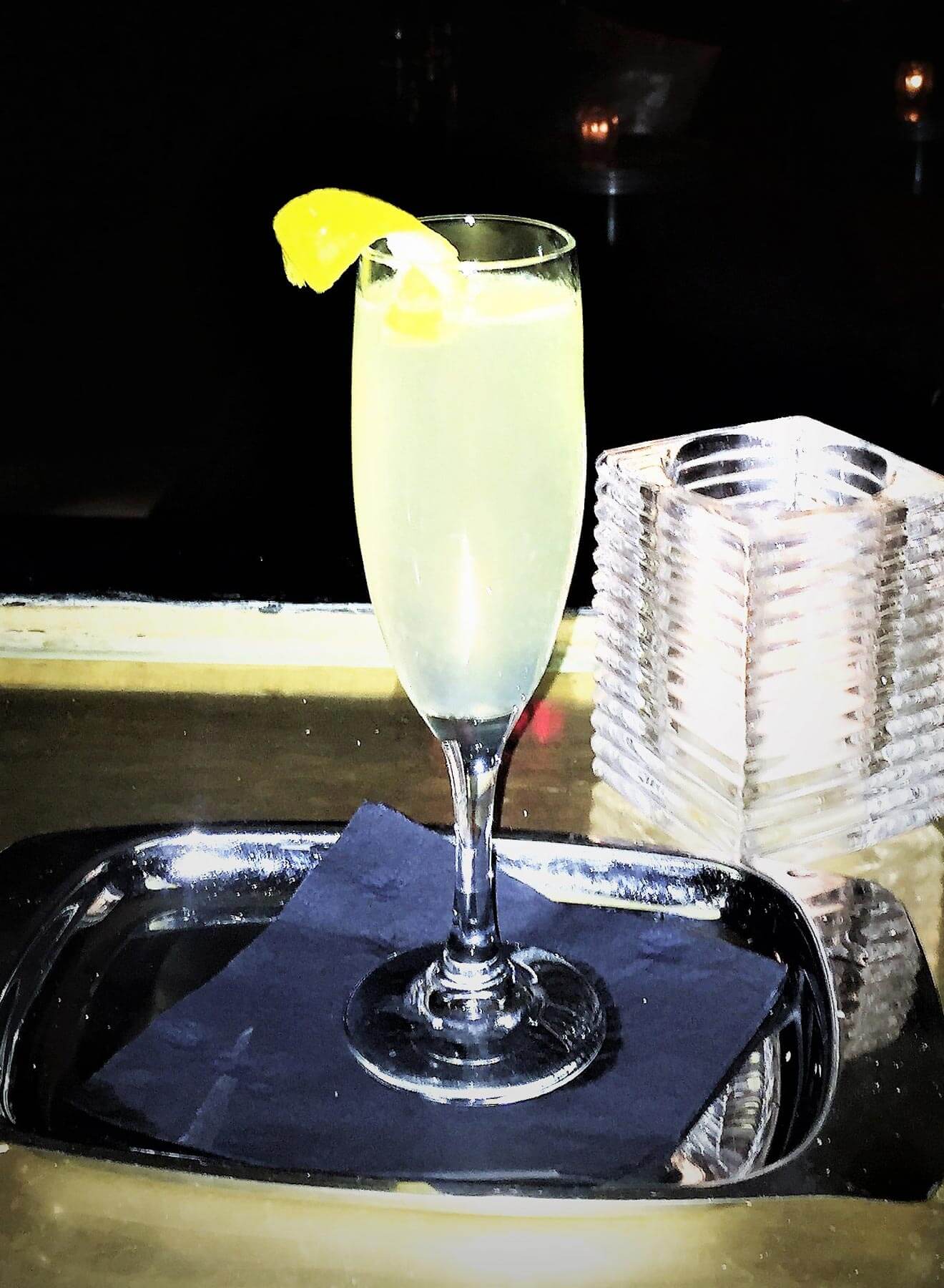 skinny 75 cocktail with garnish on silver tray