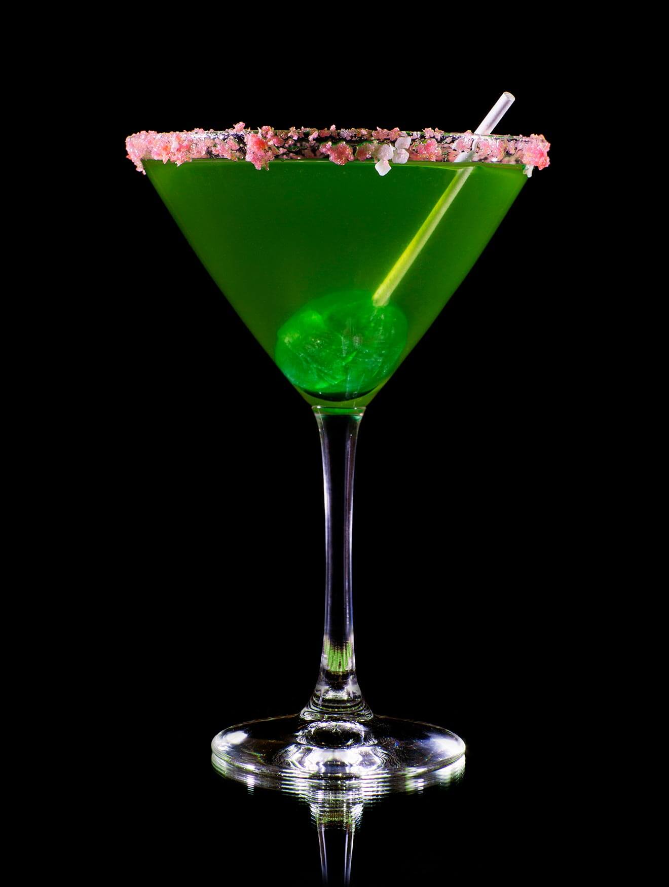 Sour Apple Lolly Martini, on black with lolly pop garnish