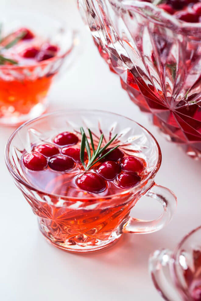 Sparkling Cranberry Rosemary Punch, serving glasses, bowl in background