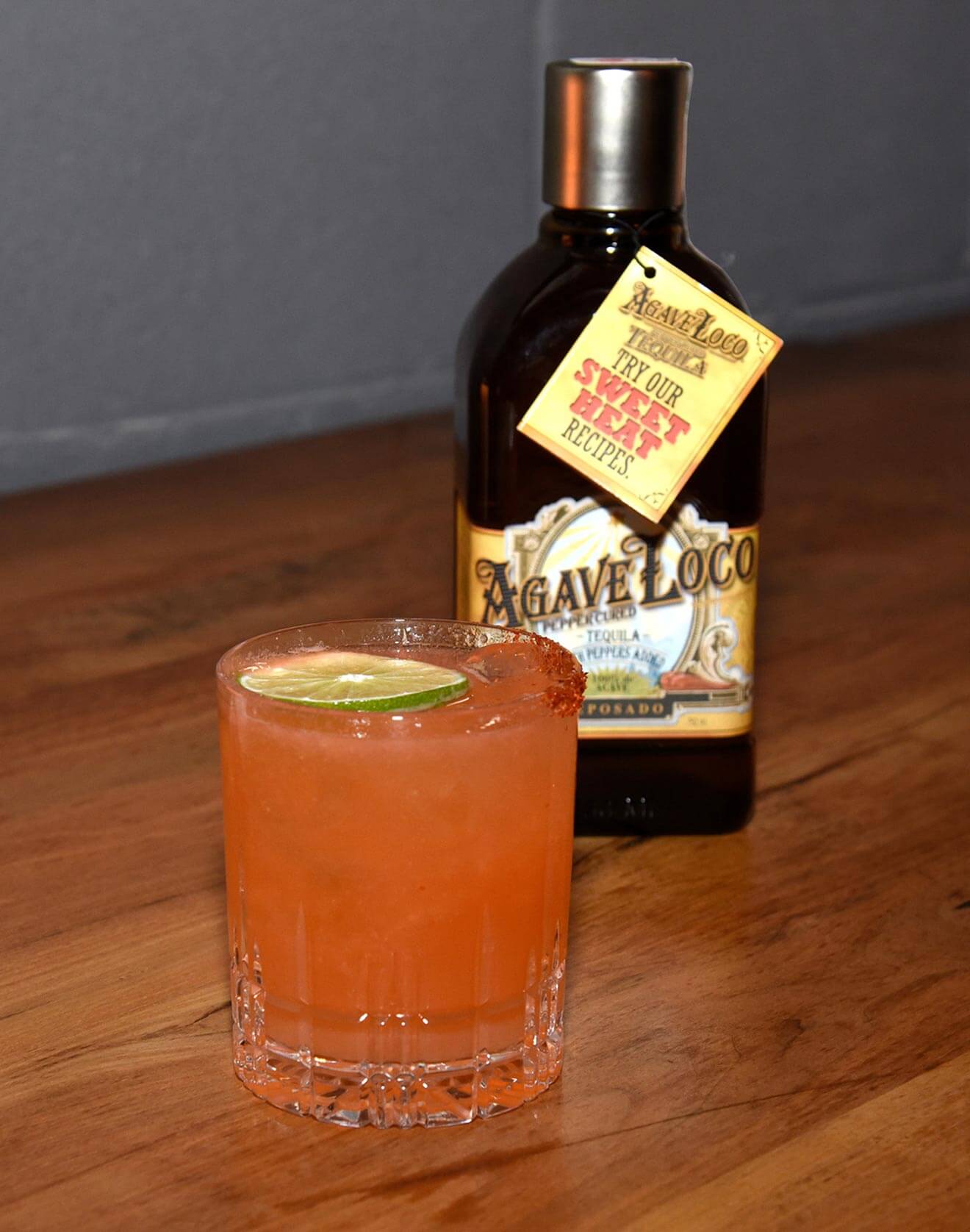 Spicy Agave Loco Paloma cocktail with bottle
