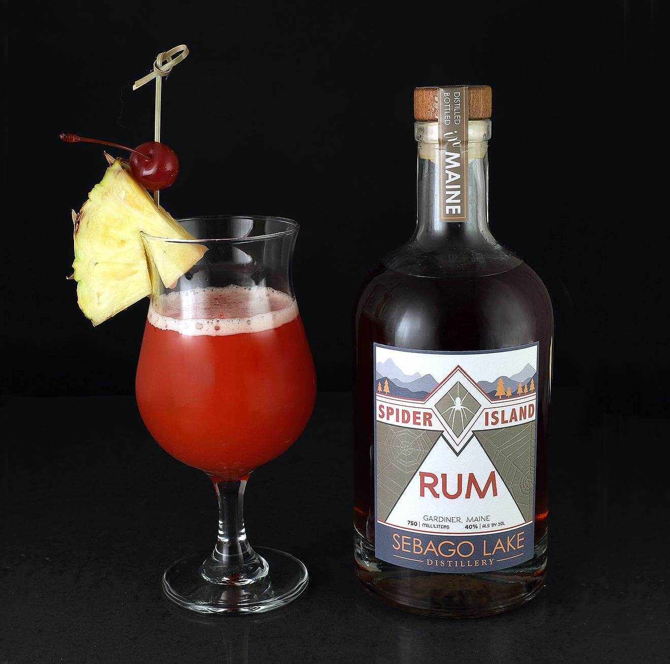 Spider Island Rum, cocktail and bottle on black