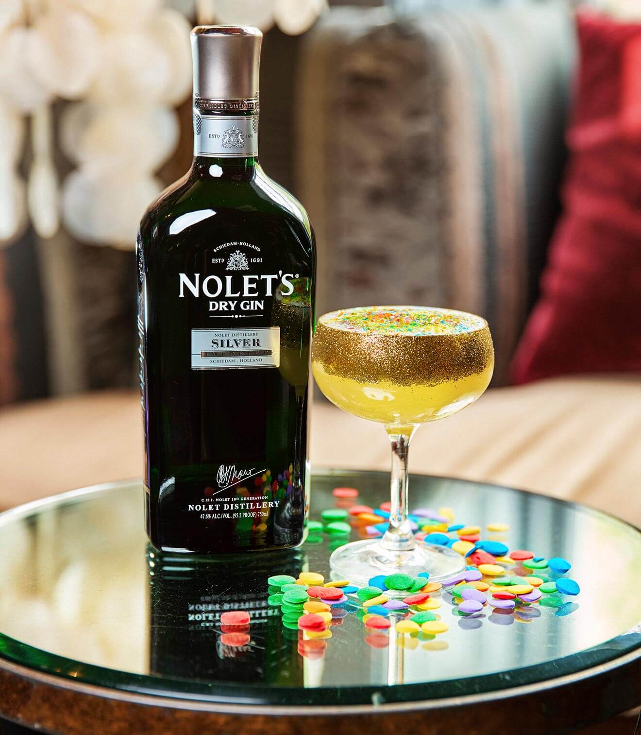 Stand Proud, with bottle and garnish on silver tray