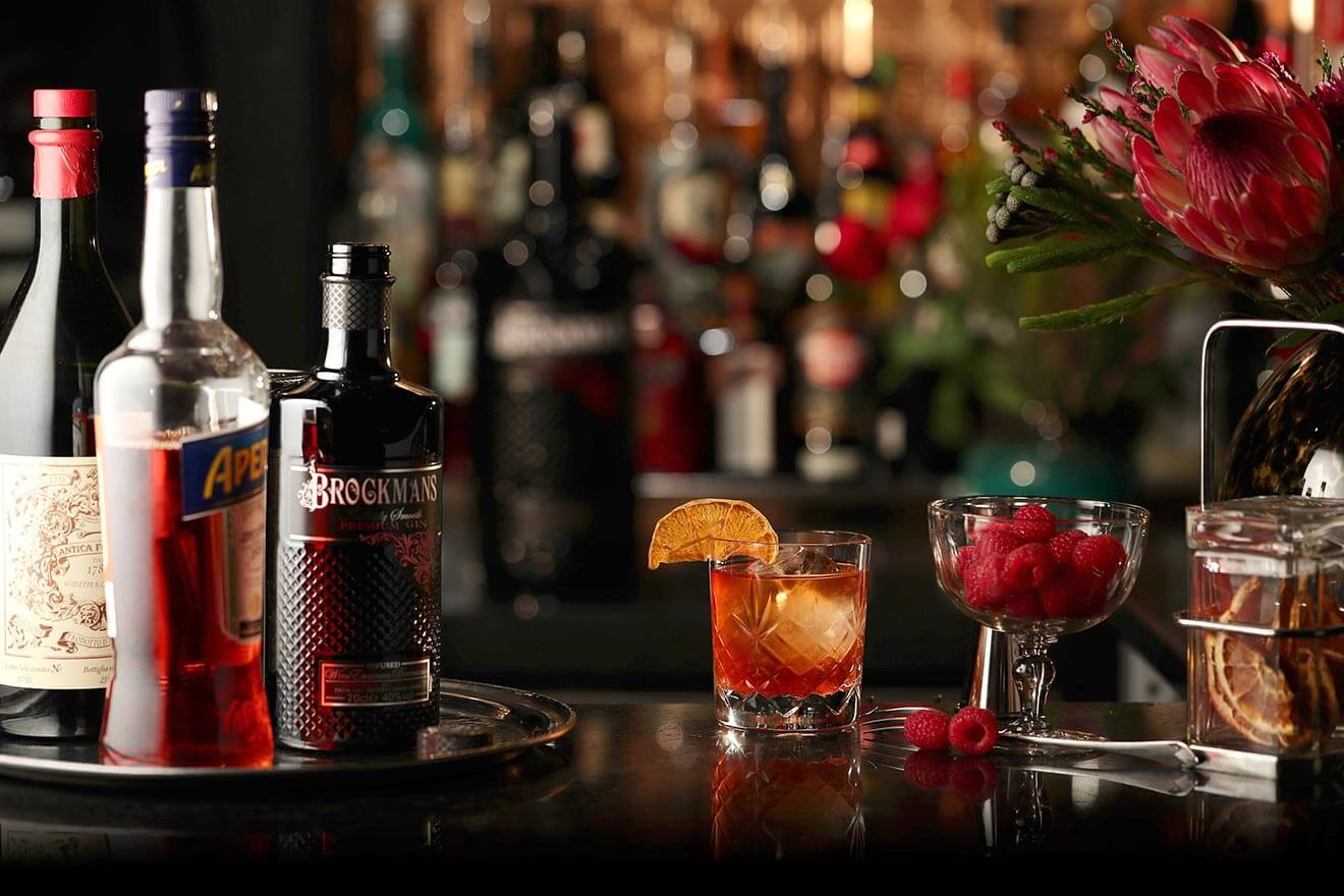 Summer Negroni, bottles, cocktail and garnishes