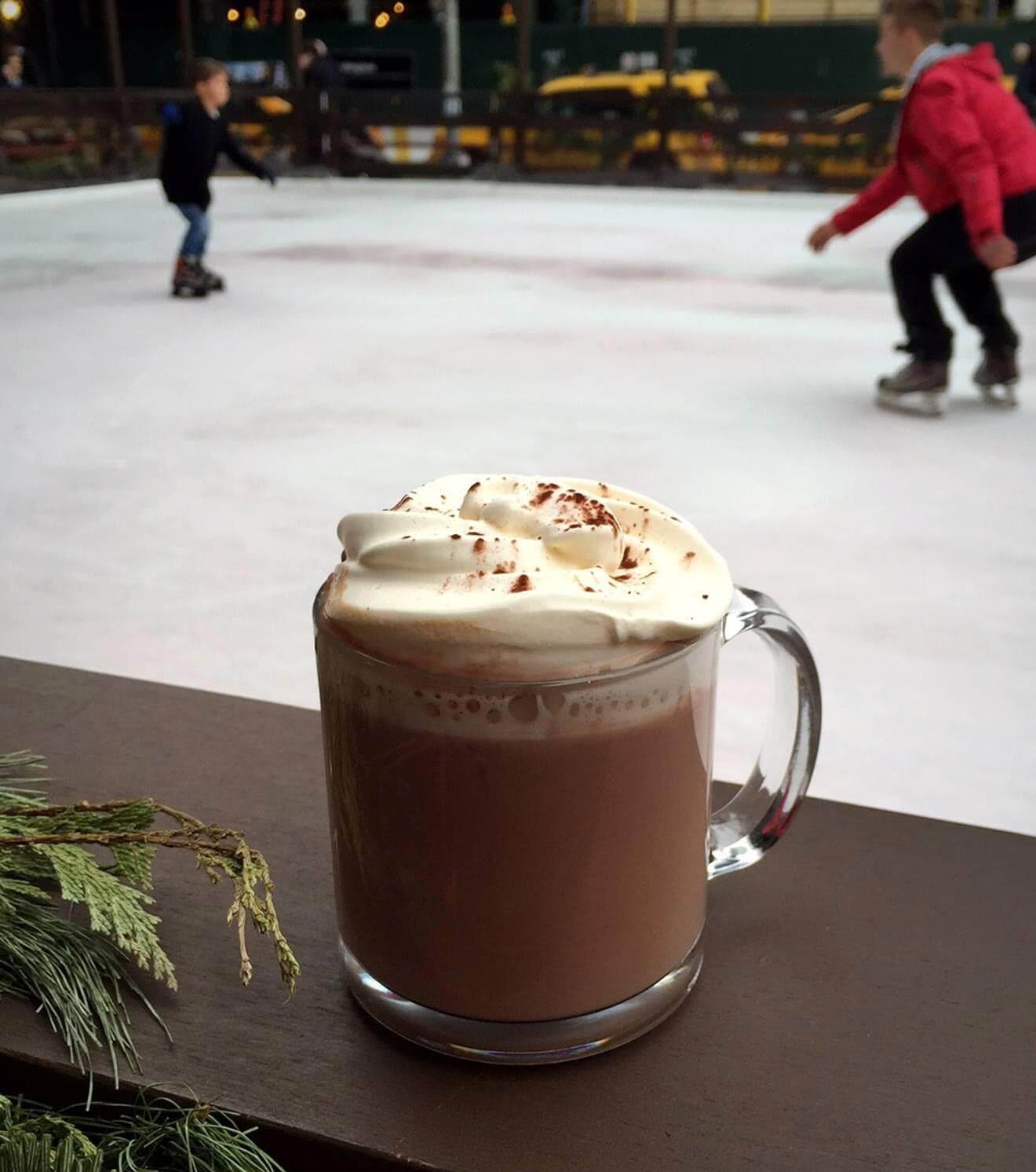 superfly cocktail with whipped cream and sprinkles, ice skaters