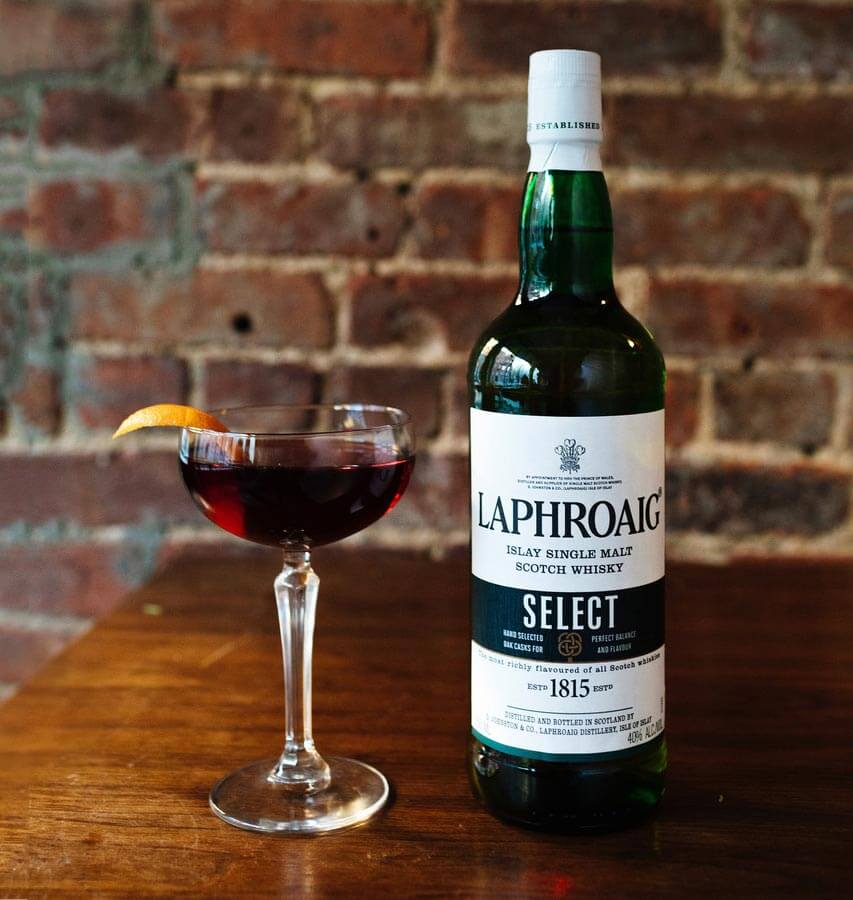 Tam O’Shanter, bottle and cocktail, brick wall background