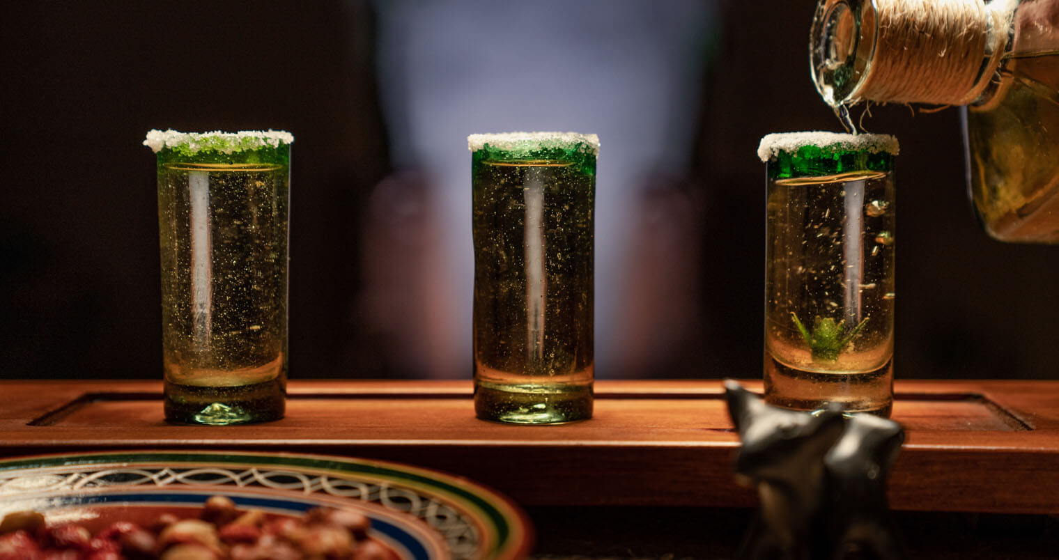 Tequila, shots being poured, featured image