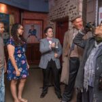 Couple admiring old drunken couple figures