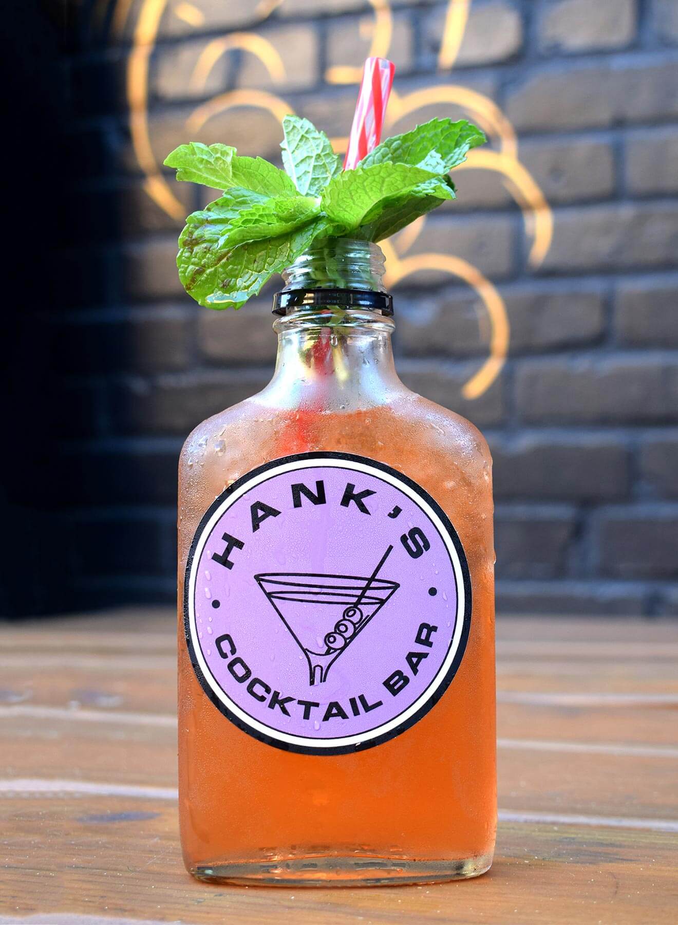 The J Street cocktail with garnish, brick wall background