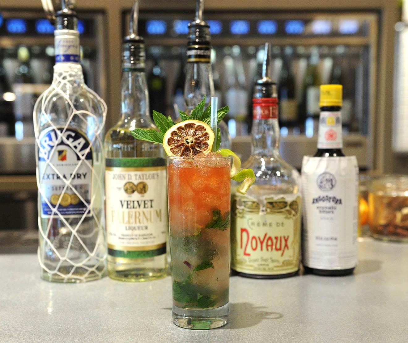 The Luck of the Tiki Cocktail, with bottle behind on table