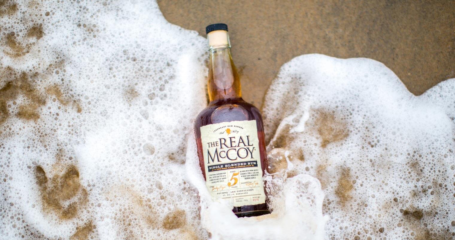 The Real McCoy 12 Year, bottle on shore, featured image