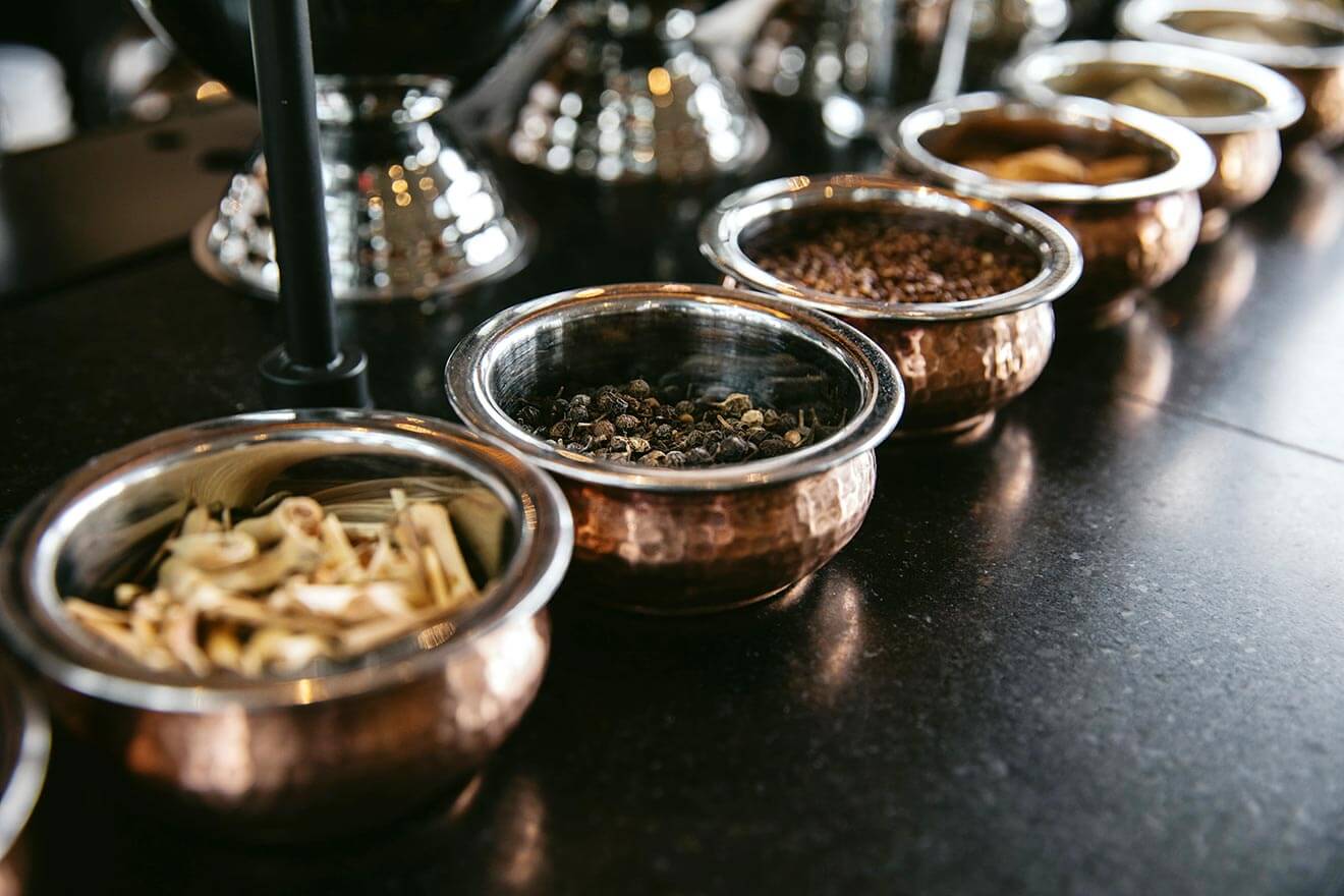 The Right Glassware is Everything, botanicals in copper bowls on display