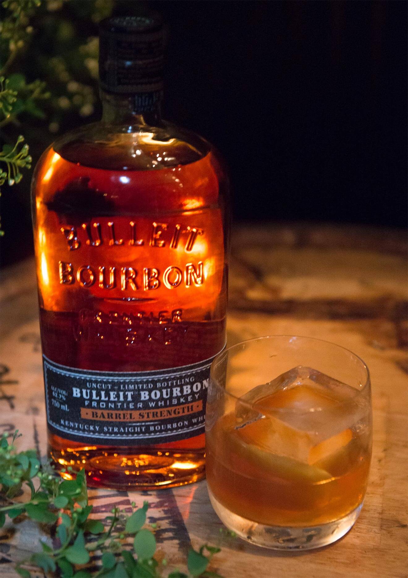 The Tradition, bourbon bottle and cocktail on rocks