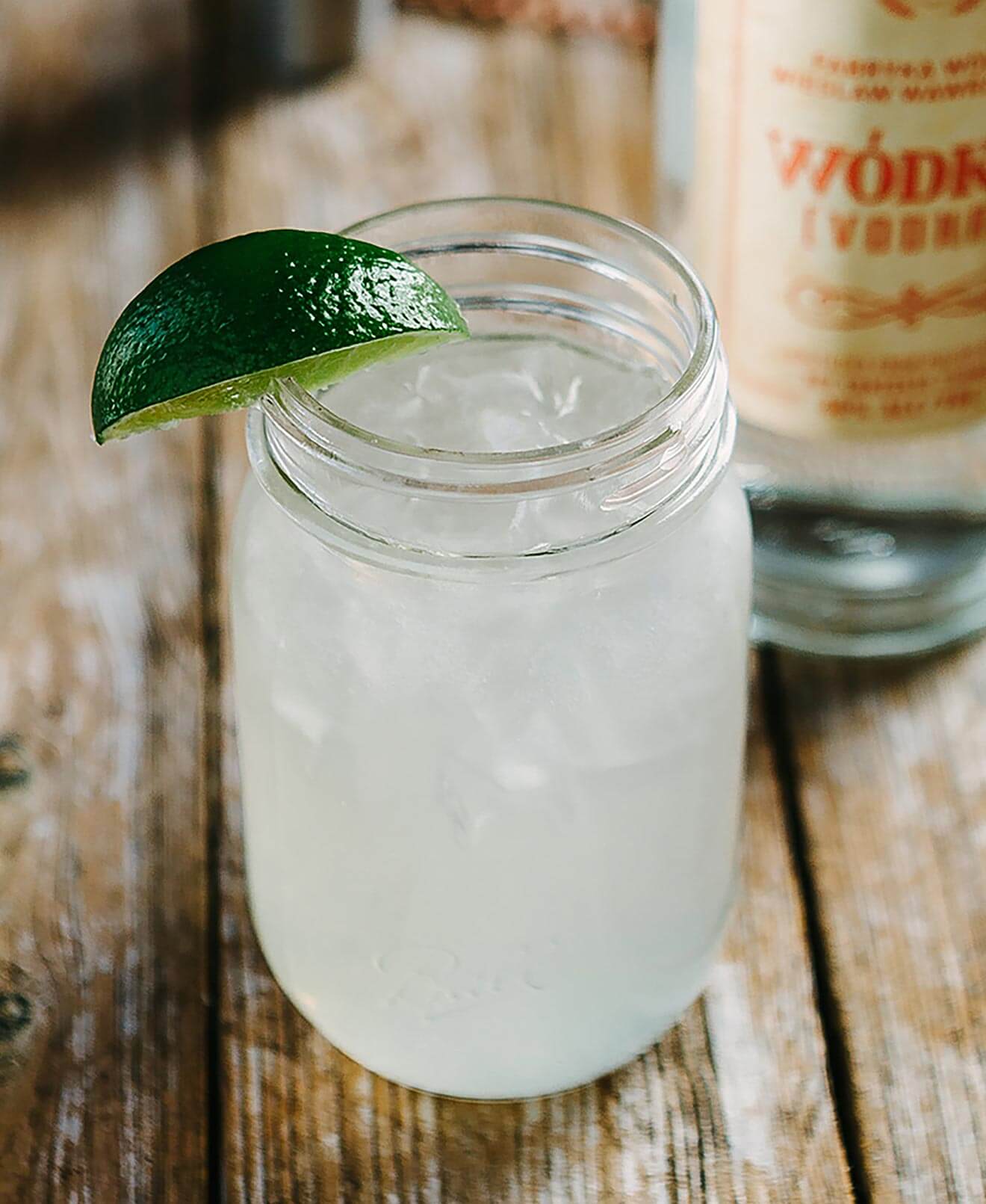 The Warsaw Mule, cocktail and bottle, wooden table
