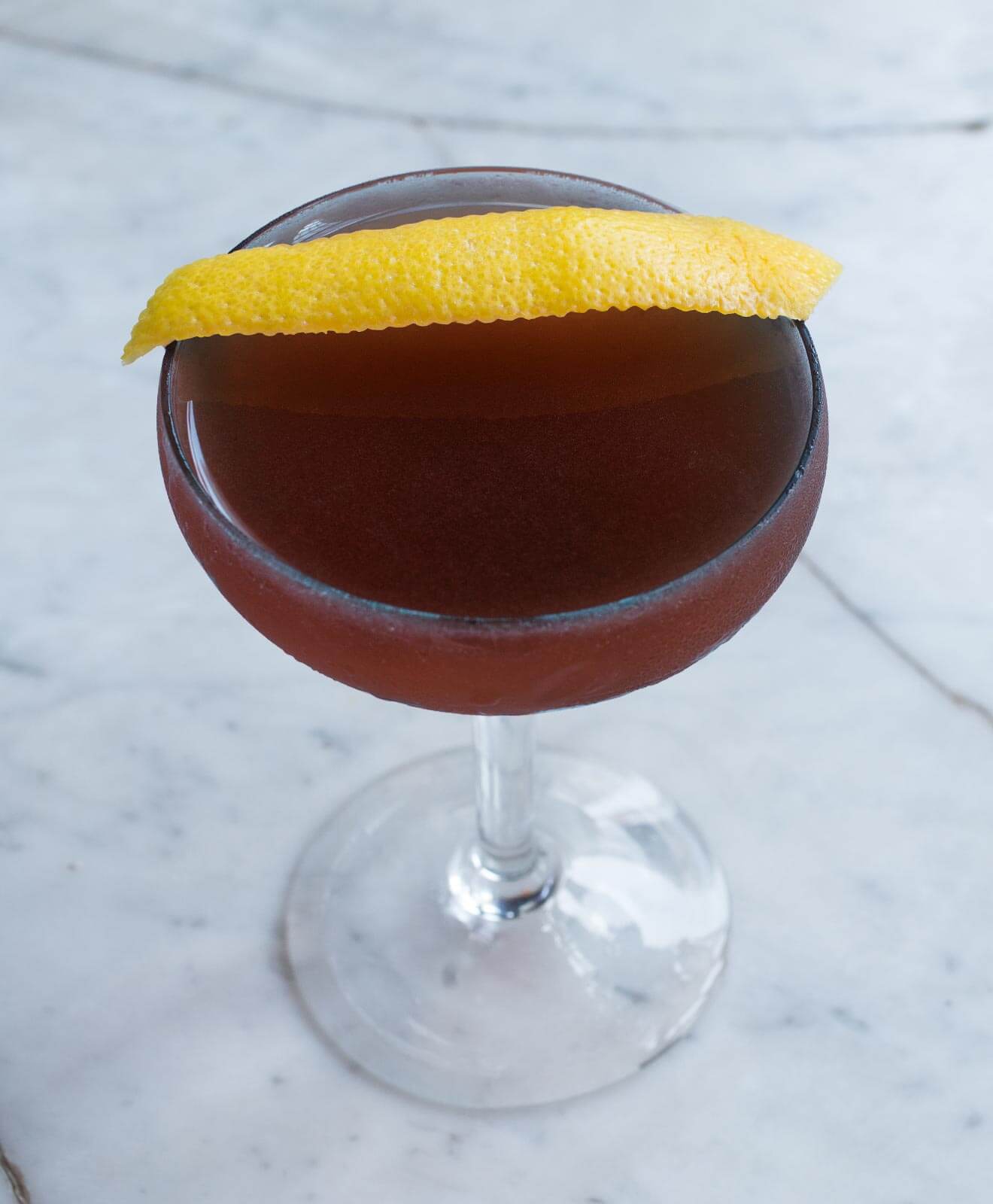 Trinidad Sour, cocktail with lemon peel garnish