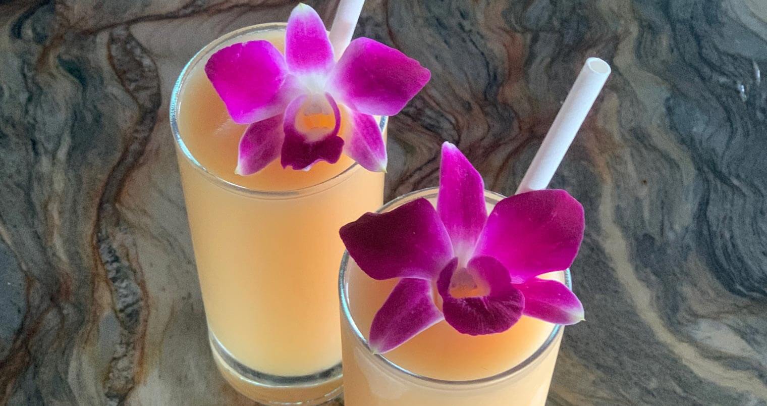 Tropic Like It’s Hot, cocktails with edible purple flower garnish, featured image