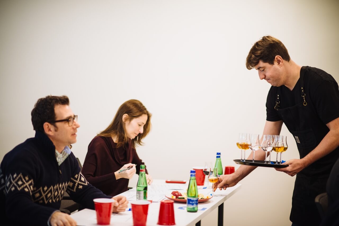 Leo DeGroff laying down a flight of spirits for USC 2015 Gin, Vodka, Vermouth judges Tad Carducci and Jennifer Simonetti-Bryan, MW.