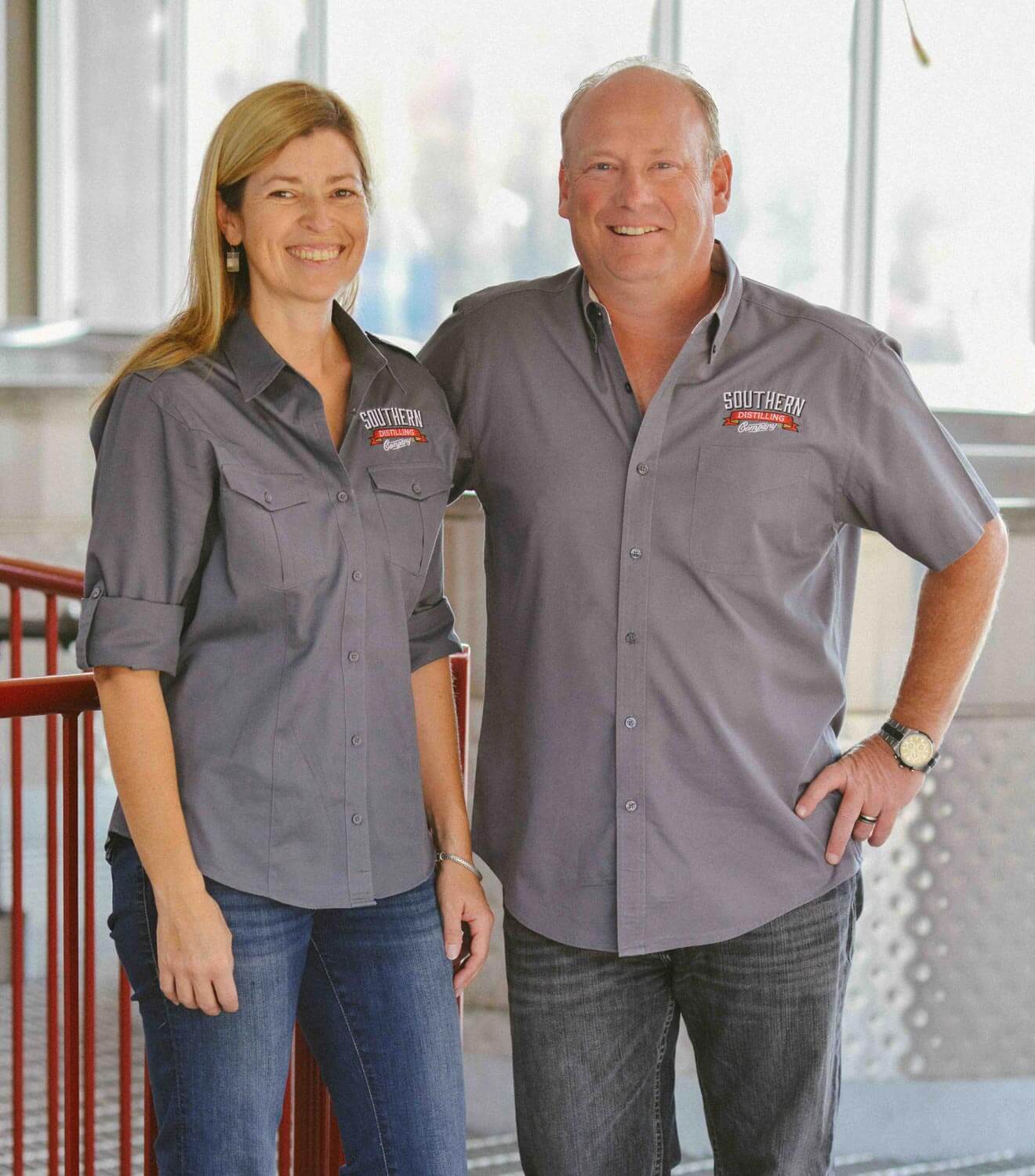 Vienna and Pete Barger of Southern Distilling Co., couple in distillery in uniform