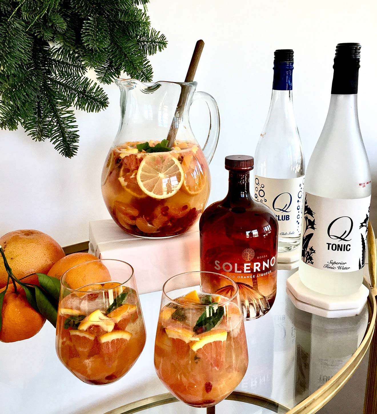 Winter Citrus Sangria cocktails with bottles and garnish