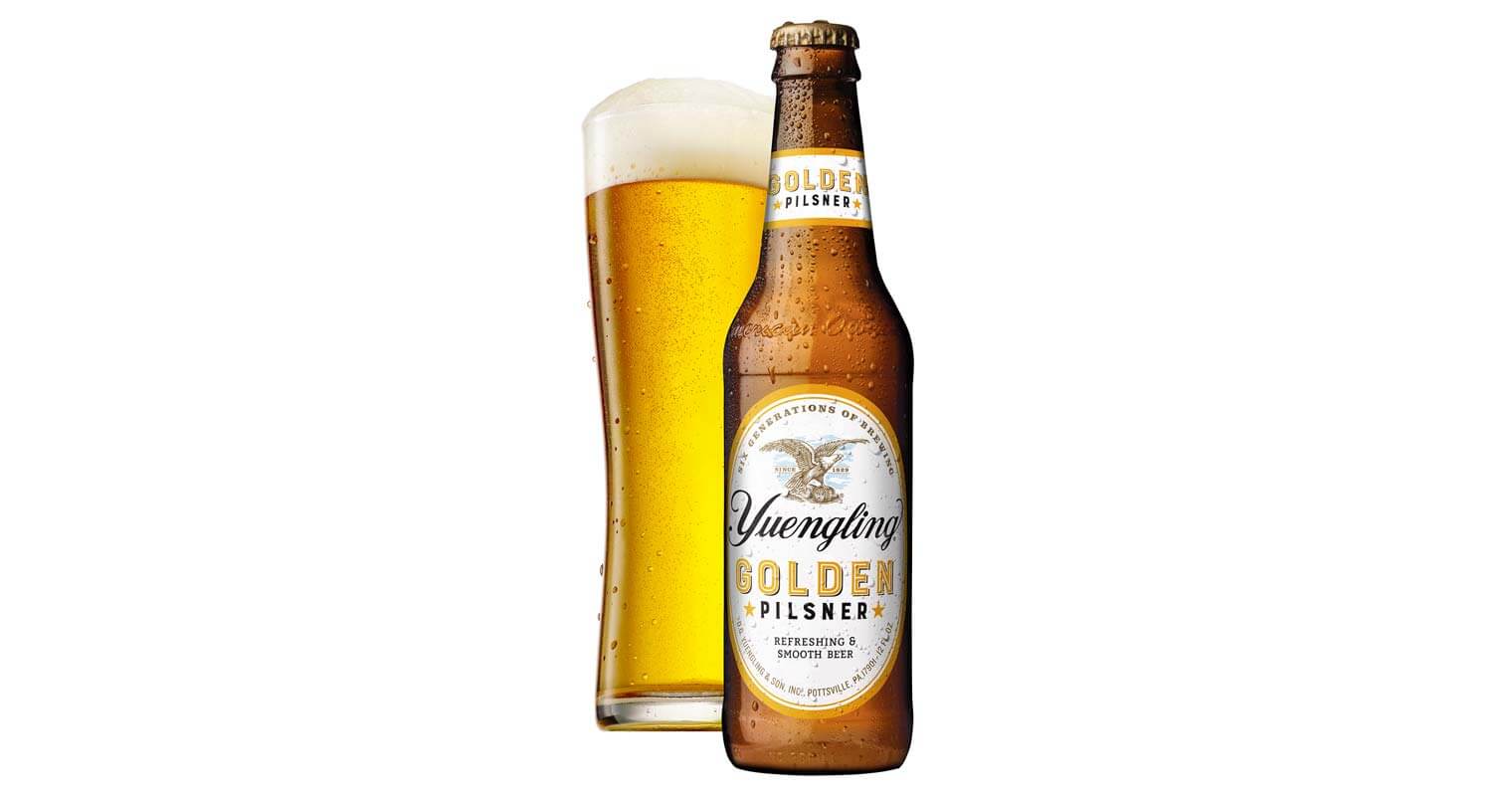 Yuengling's Golden Pilsner, bottle and glass on white, featured image