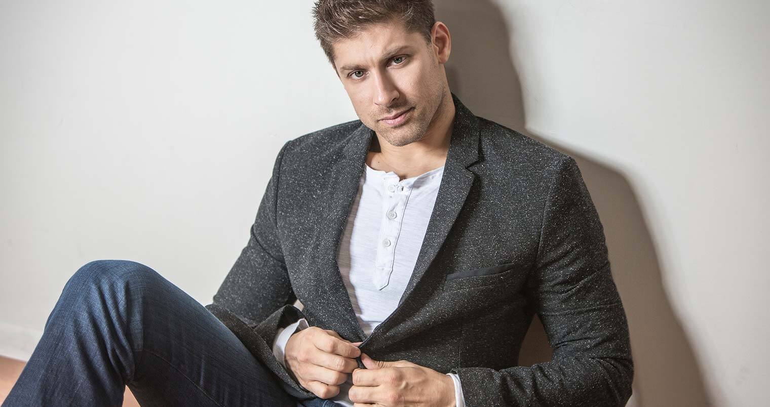 Chillin' with Alain Moussi, sitting in jeans and sport coat, featured image