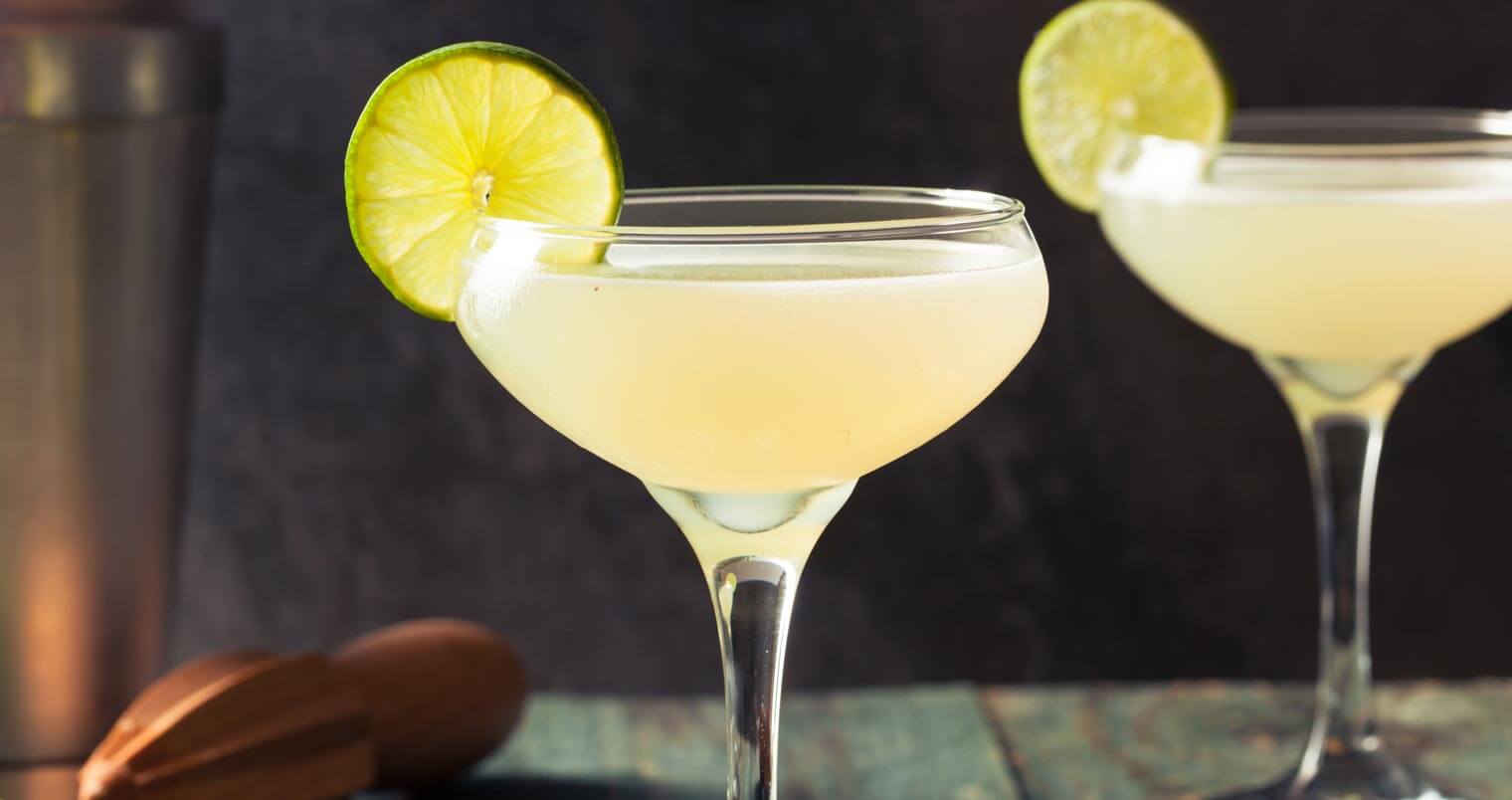 Classic Daiquiri cocktails with lime wheel garnish, featured image