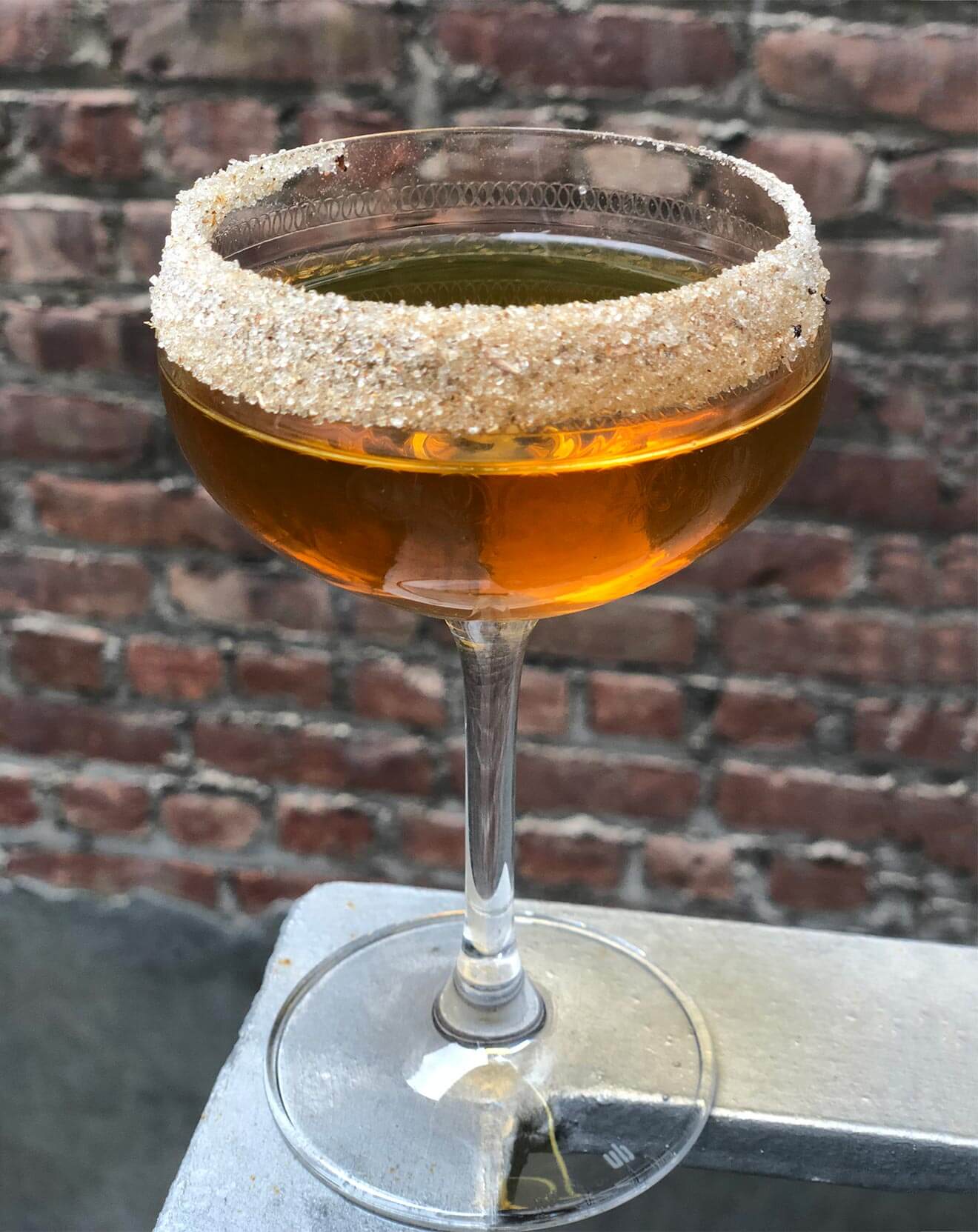 Fir Trade, cocktail with garnish, brick wall
