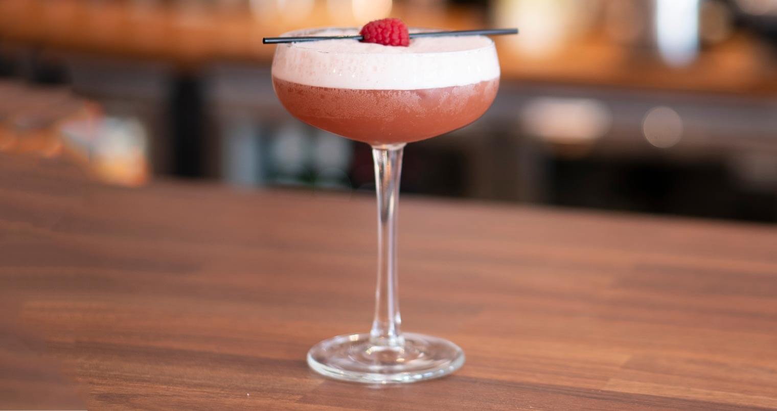 French Martini cocktail with garnish, bar top, featured image