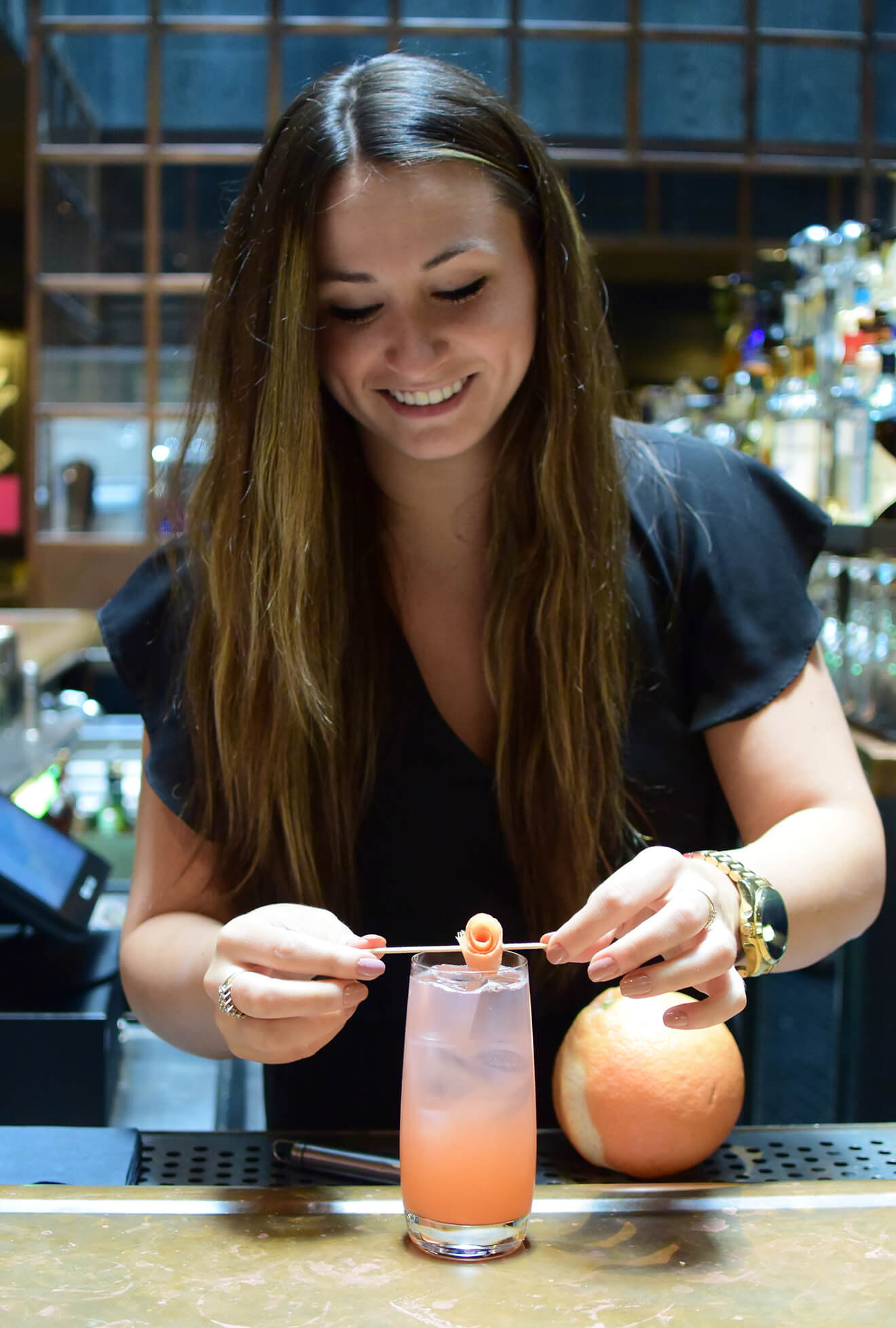 preparing the Paloma cocktail with garnish