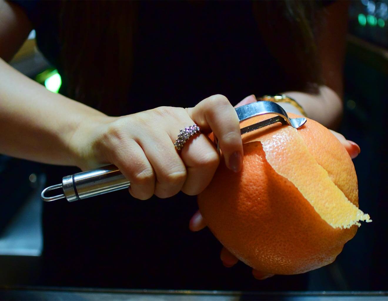 Peeling an orange peel for garnish