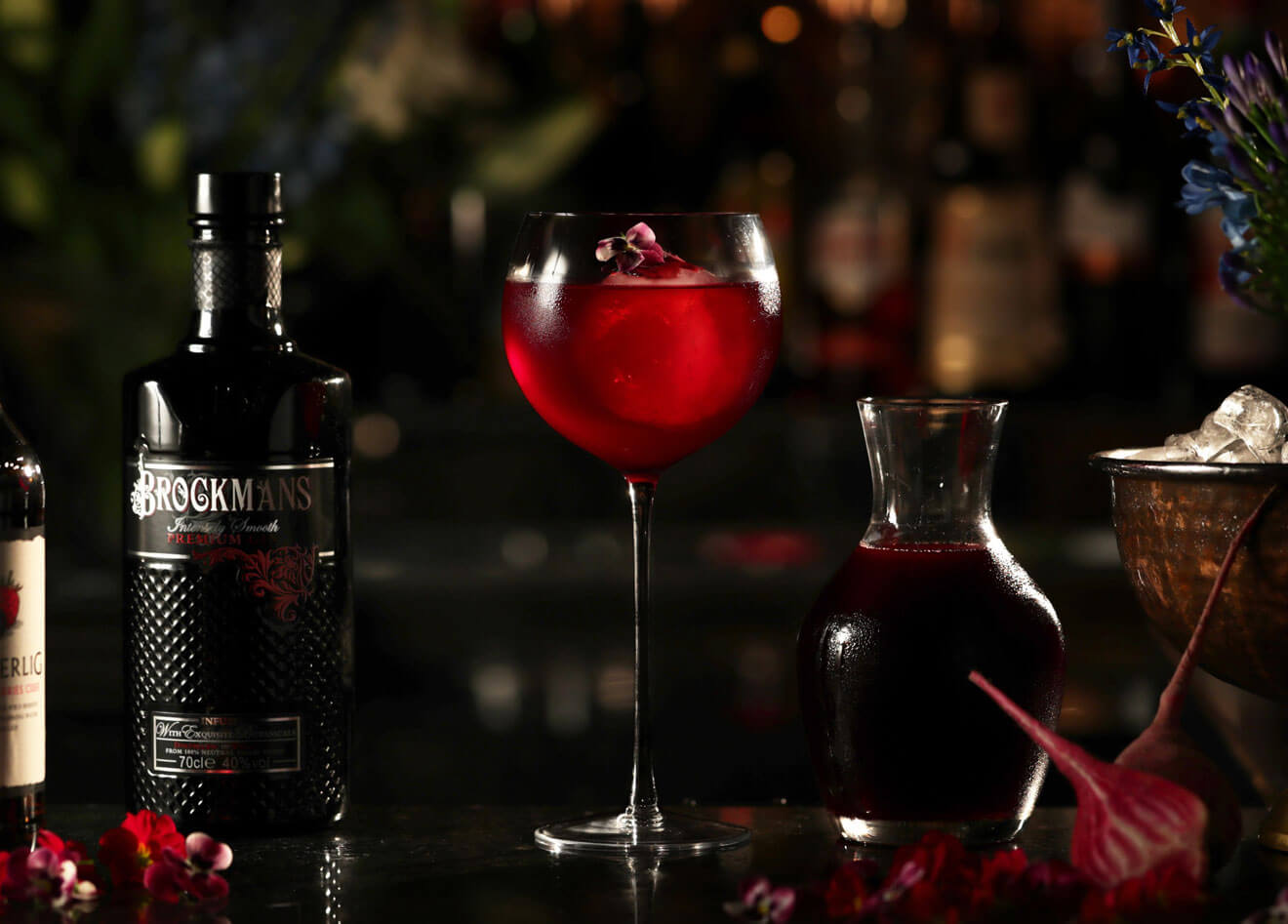 Purple Spring, cocktail with garnishes, dark background