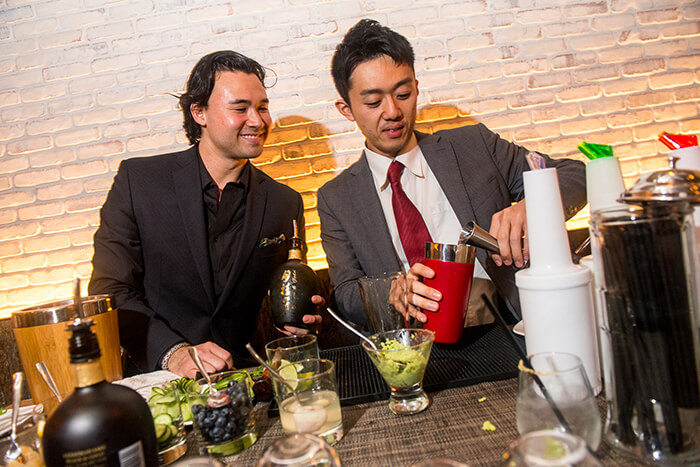 KOA Restaurant’s Toranosuke Matsuoka (left) offers advice on using sake in a cocktail to an event attendee