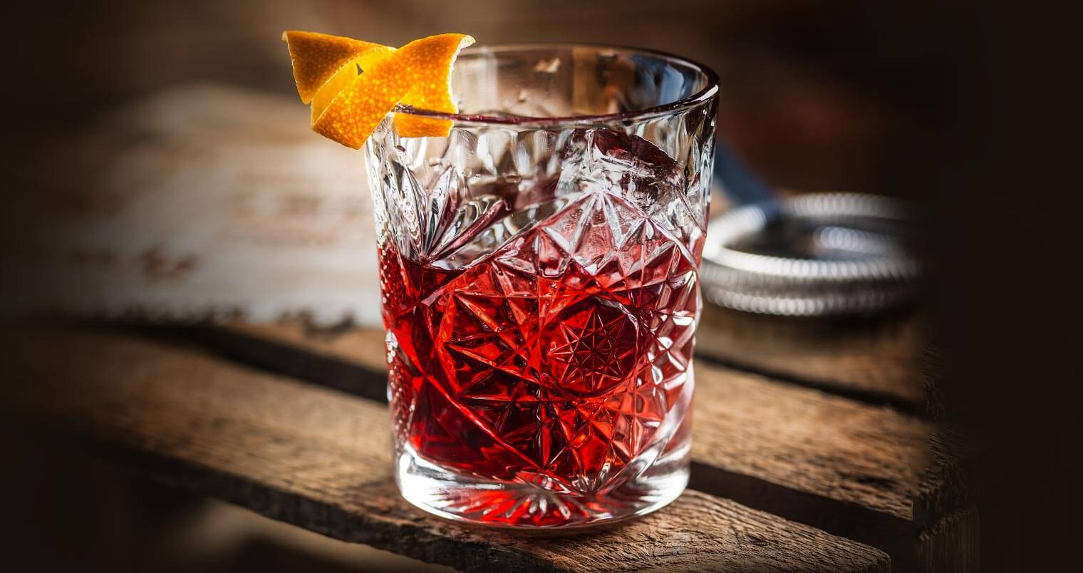 The Perfect Negroni, cocktail with garnish, wooden table, featured image
